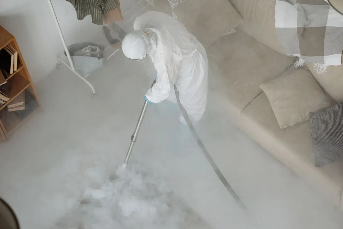 Biohazard cleanup technician in protective equipment, Canby, MN